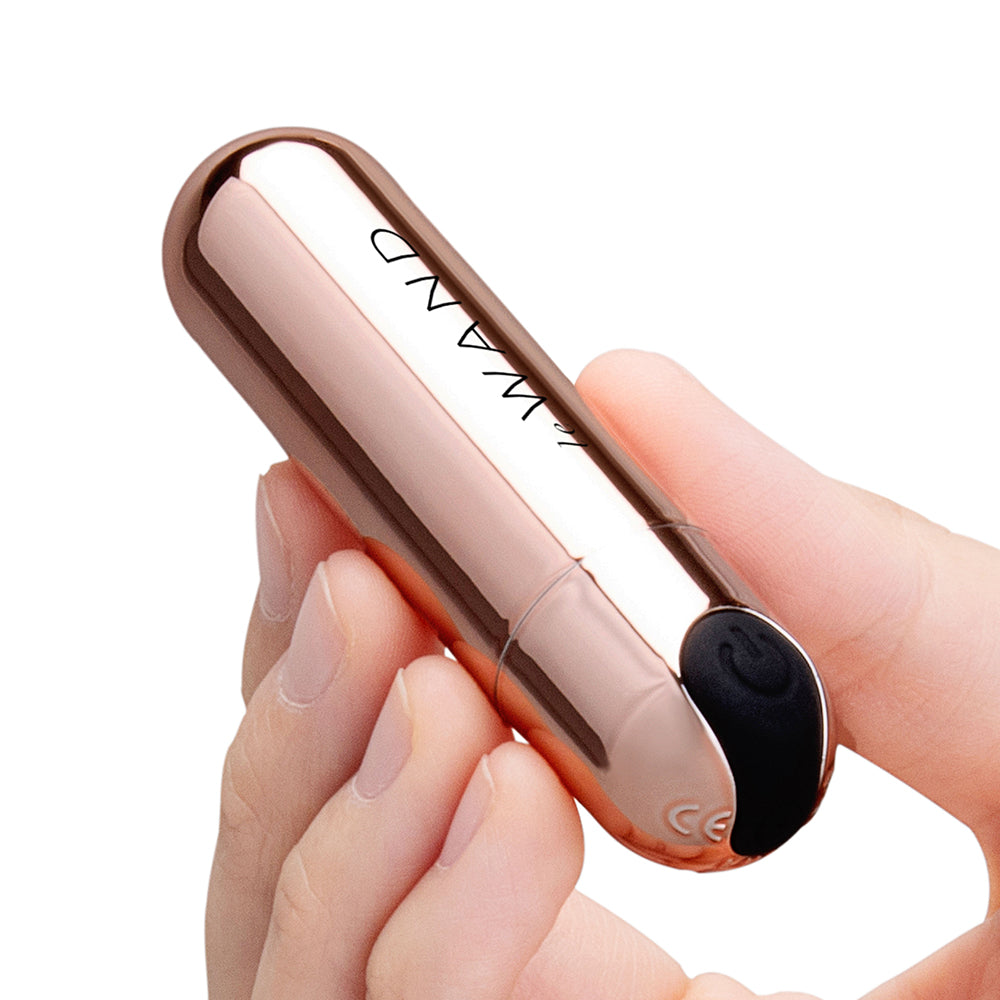 Le Wand Essentials Mini Rose Gold Bullet Vibrator held in hand, showcasing sleek design and functionality.