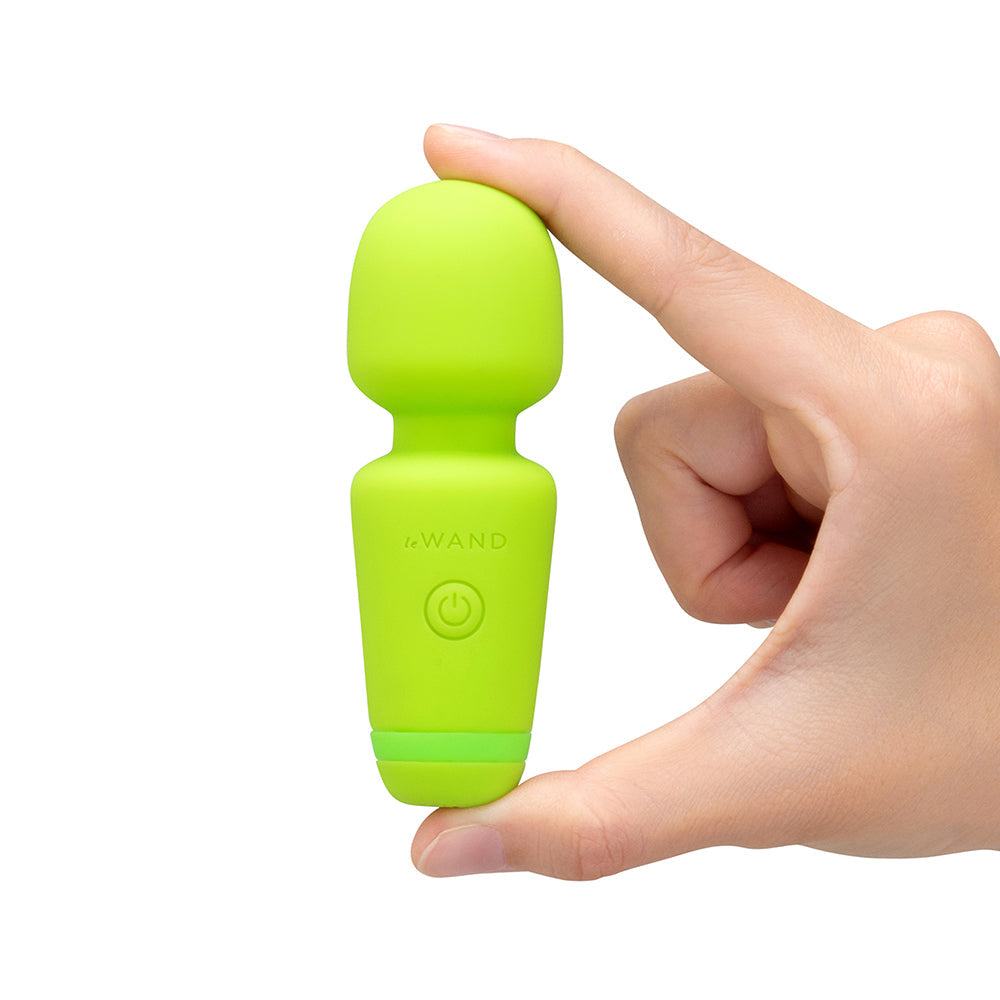 Le Wand Essentials Mini Wand Vibe Pocket-sized Vibrator held in hand, showcasing its compact and vibrant design.