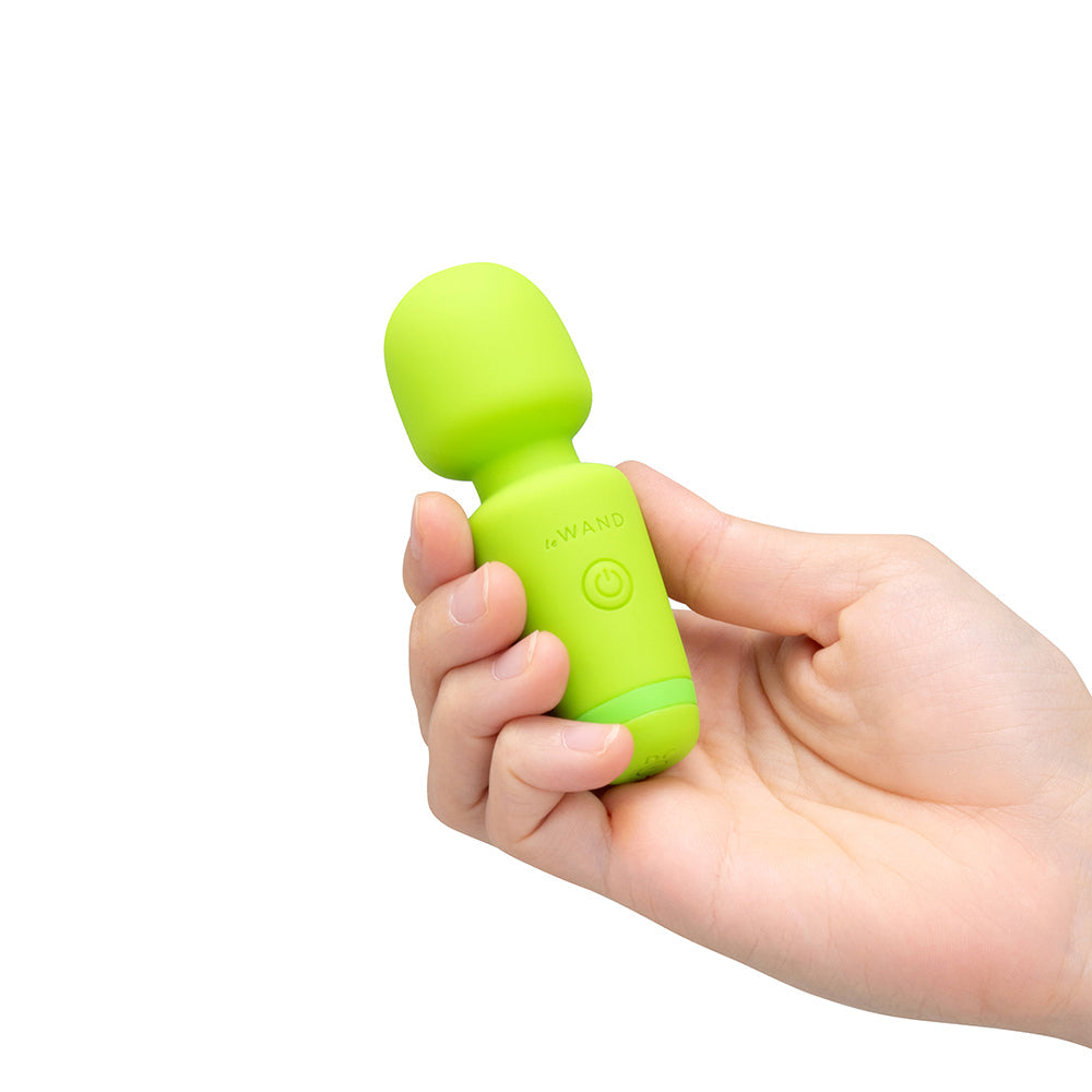 Le Wand Essentials Mini Wand Vibe Pocket-sized Vibrator held in hand, showcasing its compact design.