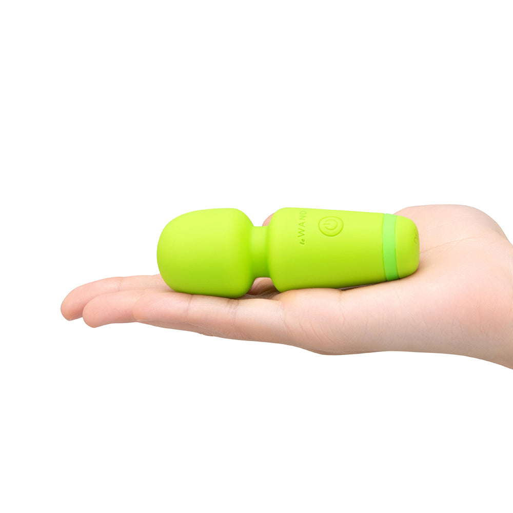 Le Wand Essentials Mini Wand Vibe Pocket-sized Vibrator held in a hand, showcasing its compact and portable design.