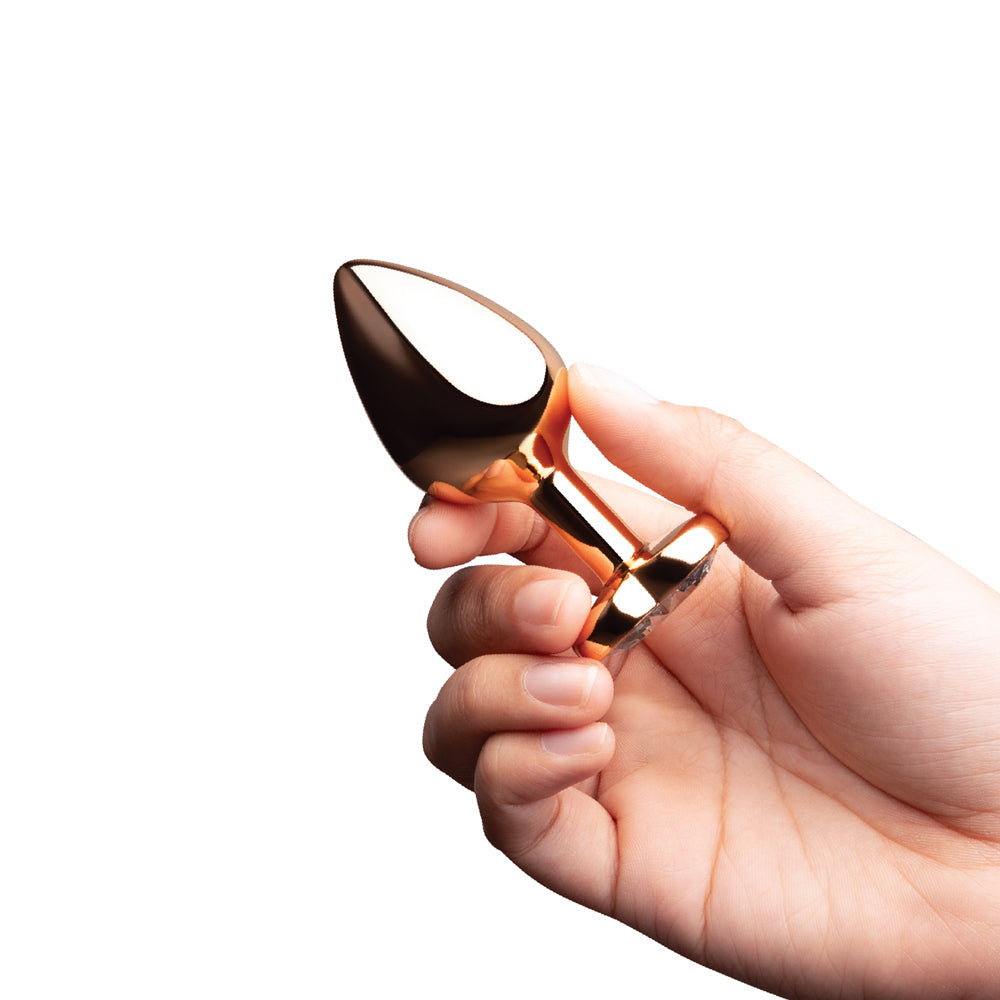B-vibe Essentials 2-piece Jewel Hearts Anal Training Set held in hand, showcasing its elegant design.
