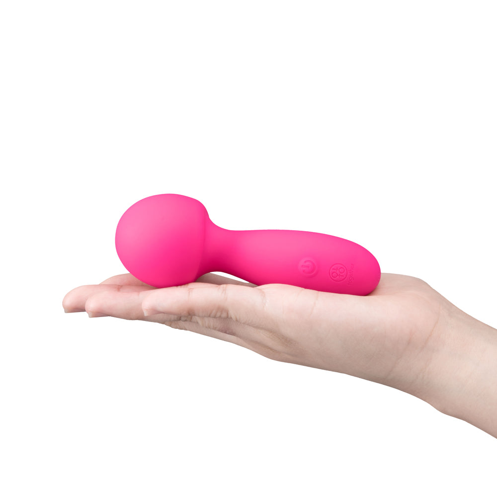 Together Spark On The Go Mini Wand Vibrator in a hand, showcasing its compact design and vibrant color.