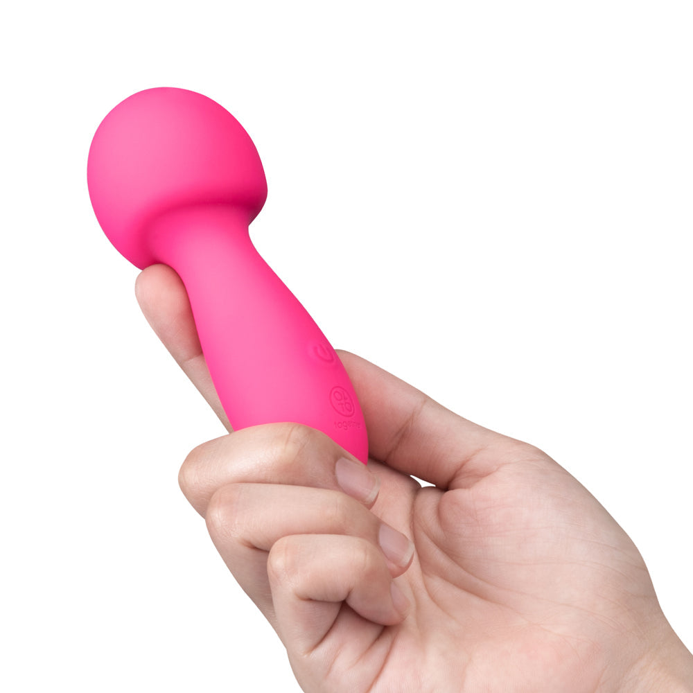 Together Spark On The Go Mini Wand Vibrator held in hand, showcasing its compact and vibrant design.