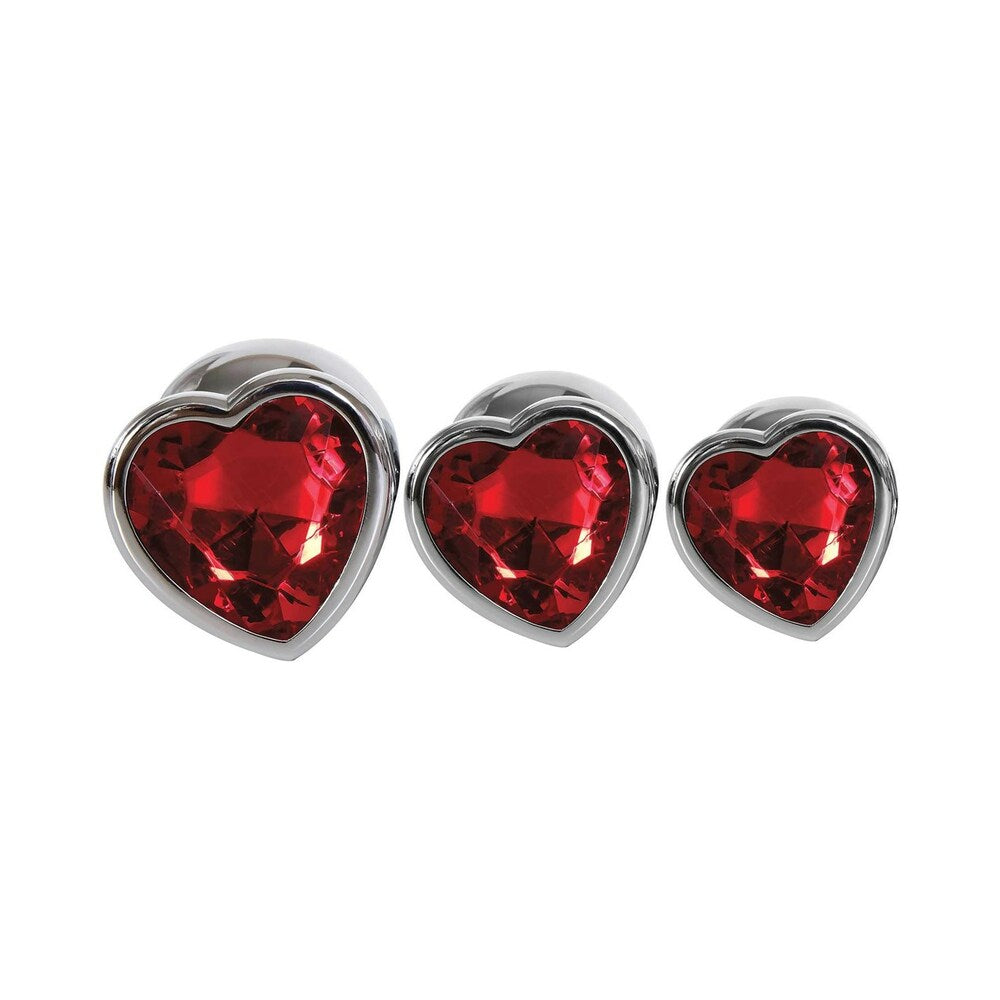 Adam & Eve Three Hearts Gem Anal Plug Set, featuring three graduated heart-shaped plugs with sparkling red gems.