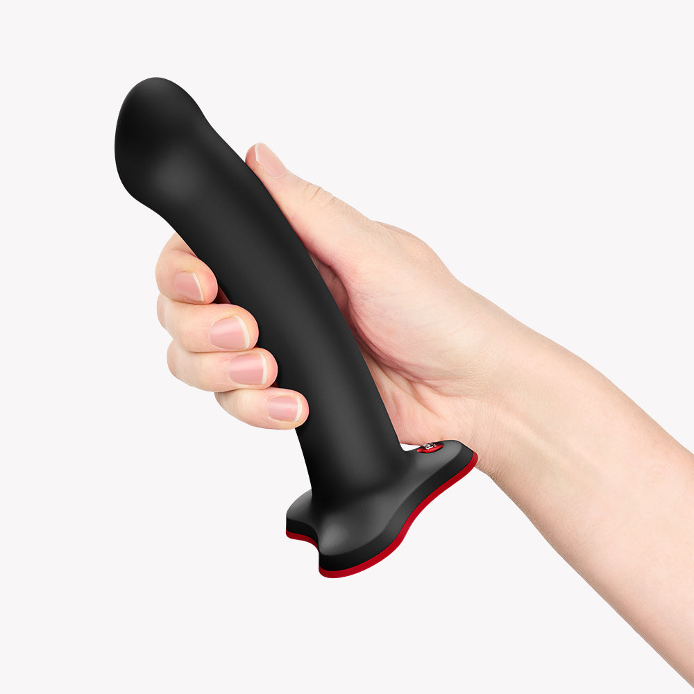 Fun Factory Magnum G-Spot Dildo Black held in hand, showcasing ergonomic design for ideal stimulation.