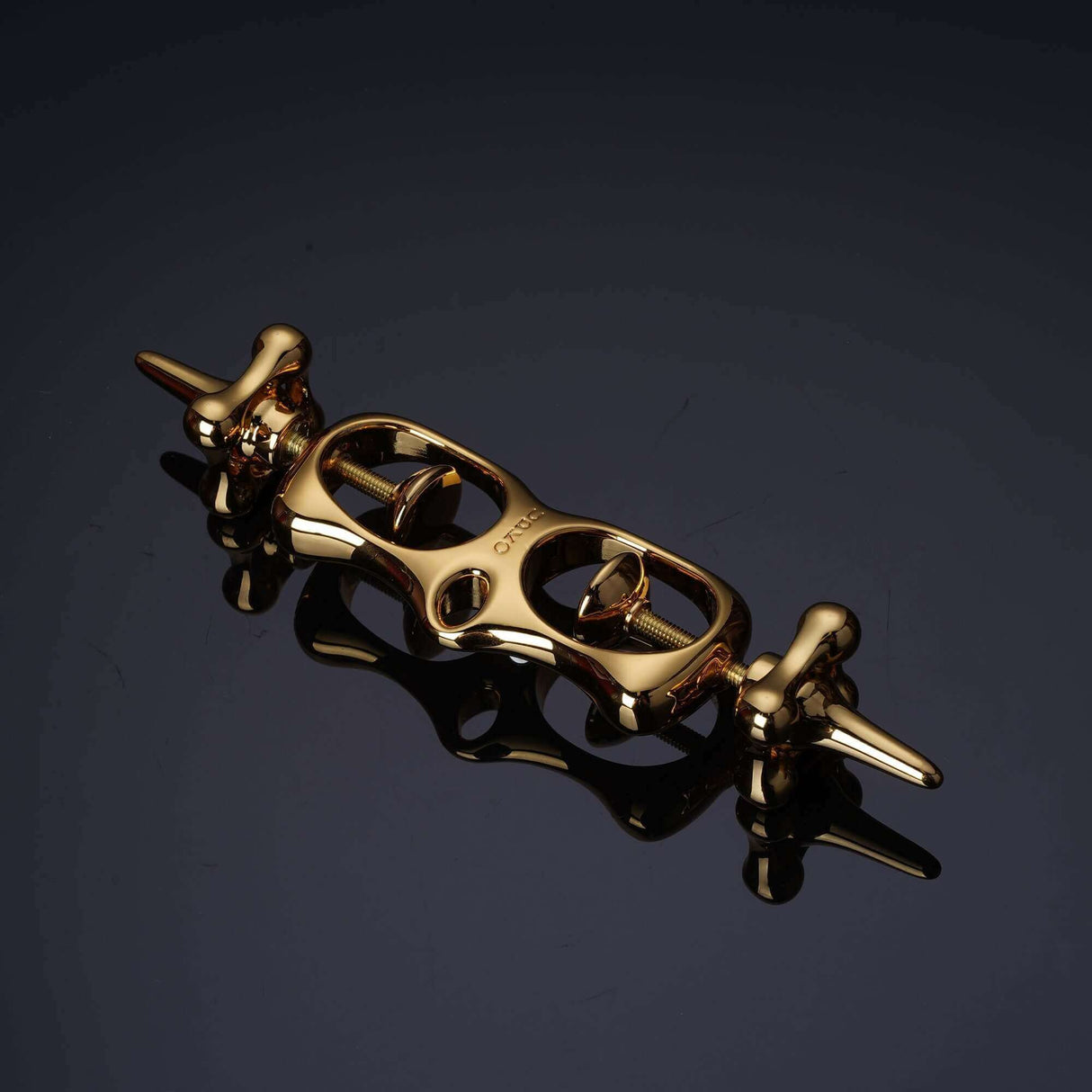 UPKO Thumb Metal Cuffs in shiny gold finish, featuring a unique pull-string mechanism for secure restraint.