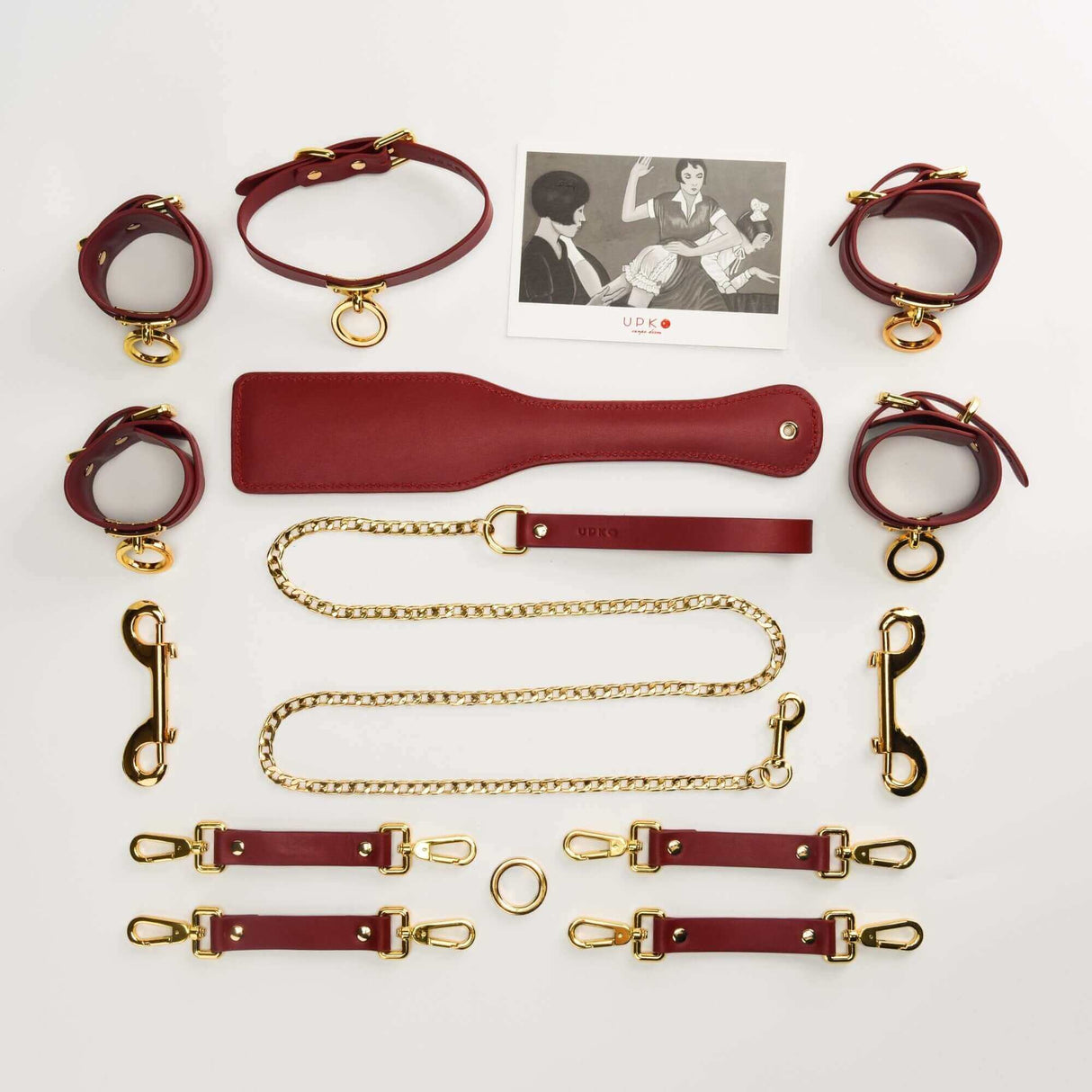 UPKO luxury red Italian leather bondage tools set with collar, leash, cuffs, and accessories in a stylish arrangement.