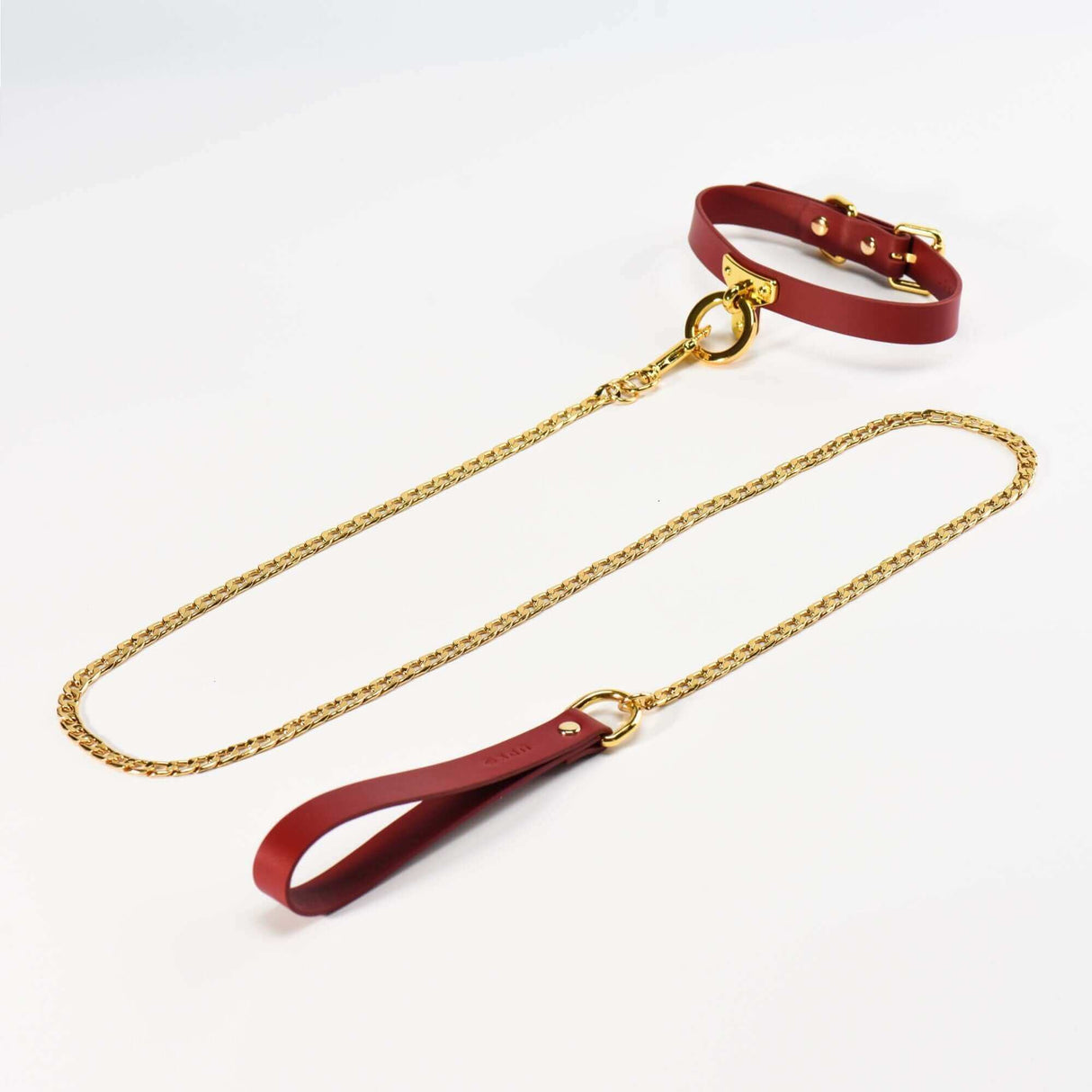 Luxurious red Italian leather collar and gold chain leash set, perfect for bondage accessories and BDSM play.