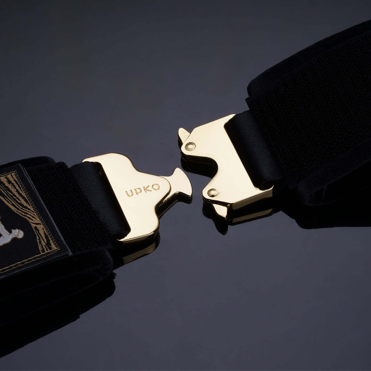 UPKO Clack Bondage Restraints with gold dual-sided buckles on black straps for versatile and secure use.