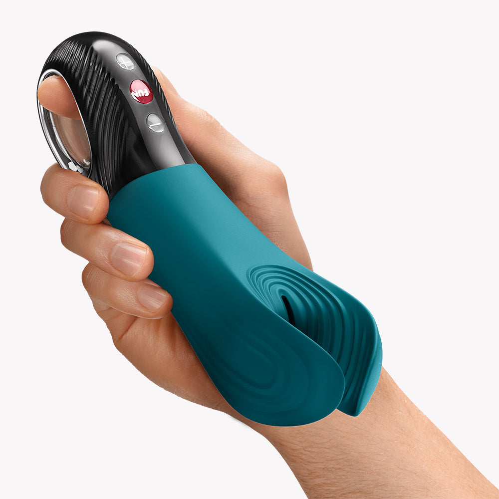 Fun Factory Manta Vibrating Masturbator Bottle Green in hand showcasing its flexible wings and controls.