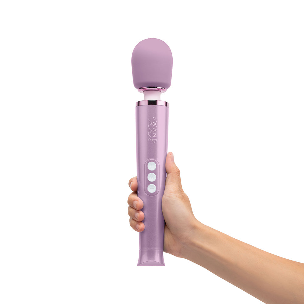 Le Wand Dive Submersible Vibrating Massager Lavender held in hand, showcasing its cordless design and waterproof features.