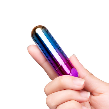Le Wand Essentials Rechargeable Rainbow Bullet Vibrator held in a hand, showcasing its sleek design and vibrant colors.