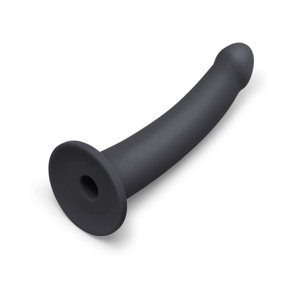 B-vibe Essentials 7 Inch Smooth Silicone Dildo Black displayed from an angle, featuring a sleek and smooth design.