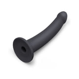 B-vibe Essentials 7 Inch Smooth Silicone Dildo Black displayed from an angle, featuring a sleek and smooth design.