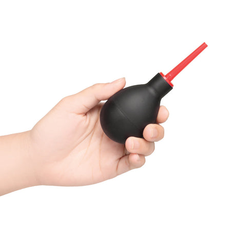 b-Vibe Essentials Mini Travel Enema Set 30 ml in hand showcasing compact design for anal hygiene.