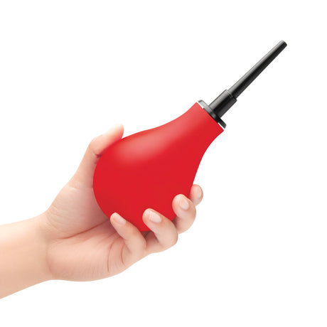 b-Vibe Essentials Hydrobulb Anal Douche 200 ml in hand, red squeezable bulb for anal hygiene preparation.
