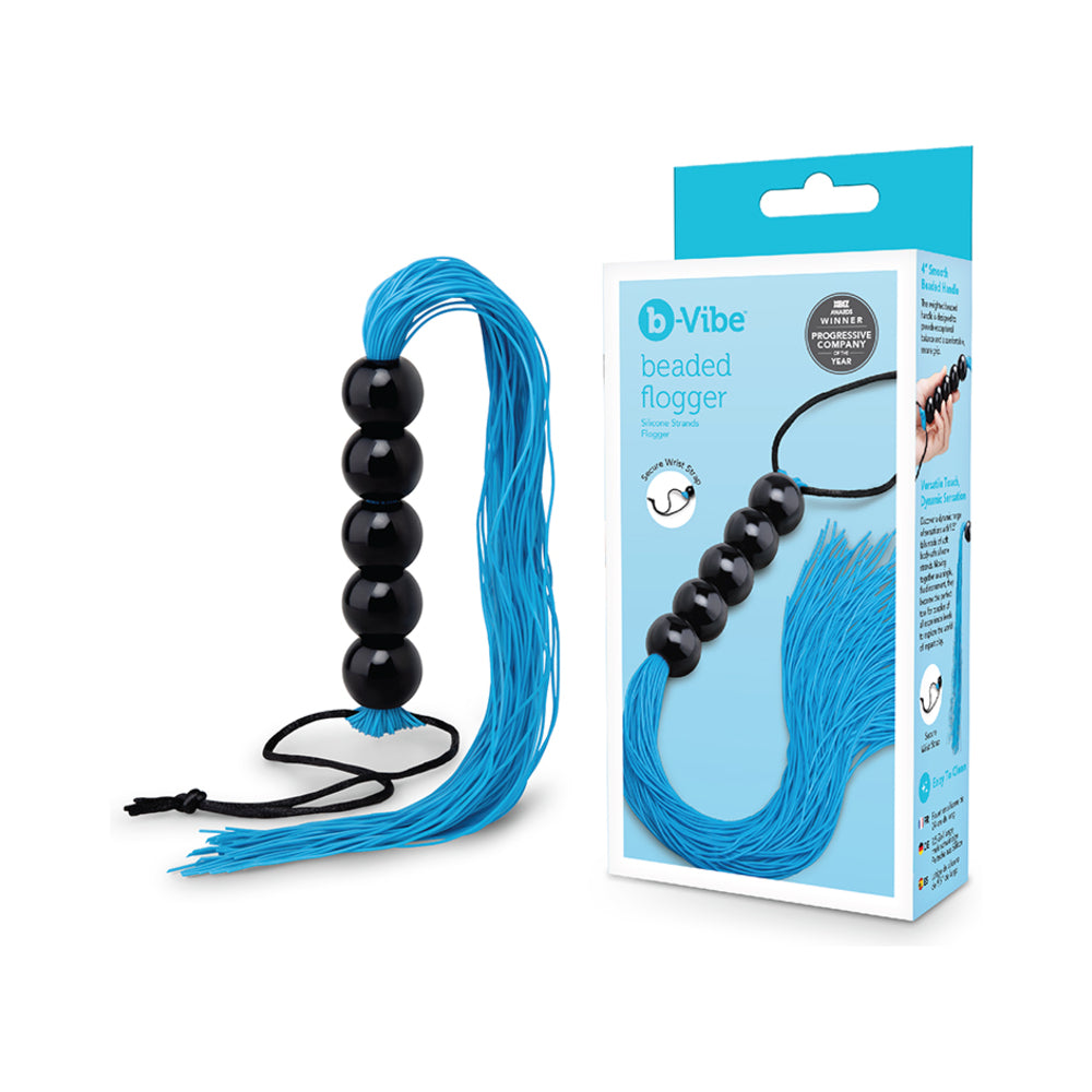 B-vibe Essentials Beaded Flogger displayed next to its packaging, showcasing the beaded design and silicone strands.