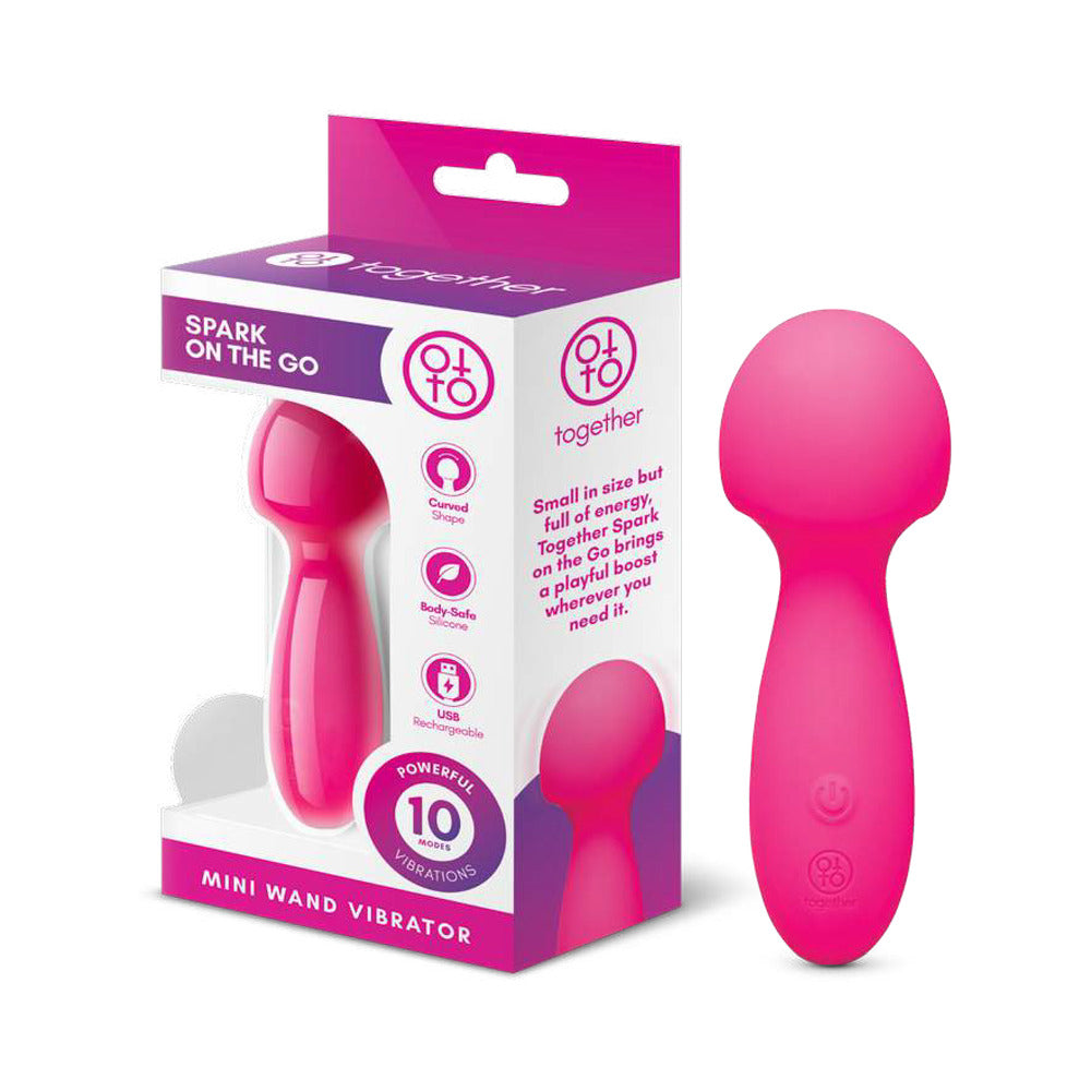 Together Spark On The Go Mini Wand Vibrator in pink packaging, highlighting its compact design and playful features.