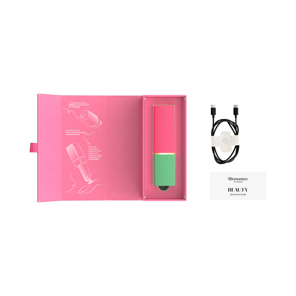 Womanizer Beauty Air Pulse Stimulator Green & Pink in packaging with quick guide and charging cable.