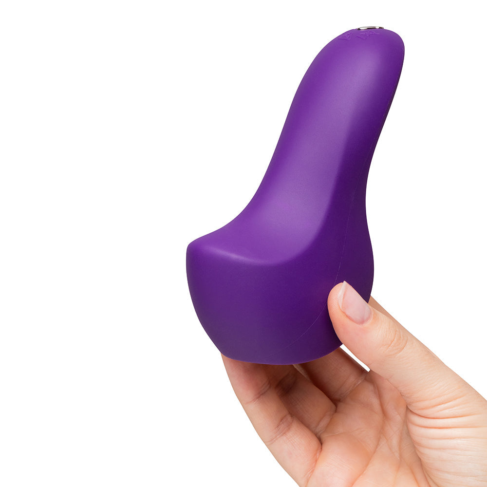We-Vibe Shared Touch Couples Grinding Vibrator Purple held in hand, showcasing its ergonomic design for couple stimulation.