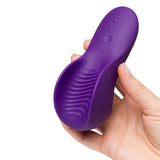 We-Vibe Shared Touch Couples Grinding Vibrator Purple held in hand showcasing its ergonomic design.