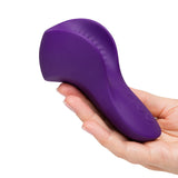 We-Vibe Shared Touch Couples Grinding Vibrator Purple held in hand, showcasing its ergonomic design.
