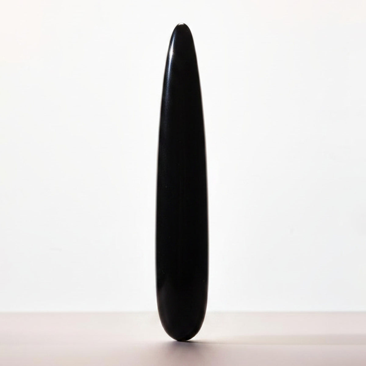Chakrubs Xaga Slim Non-Phallic Dildo, a sleek black design offering minimalist internal pleasure.