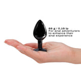 Dorcel Diamond Anal Plug Black Medium held in a hand, designed for anal adventurers seeking enhanced sensations.