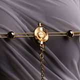 UPKO Double Bar Vibration Nipple Clamps with Clitoral Chain on mesh fabric background.