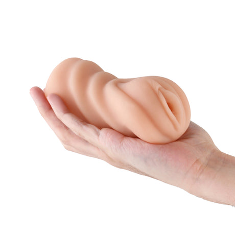 Hustler's Barely Legal Carrie Stroker Tan held in a hand, showcasing its realistic design and soft texture.