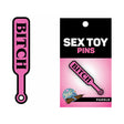 Wood Rocket Sex Toy Pin Bitch Paddle Pink is a playful enamel lapel pin featuring a bright pink paddle design.