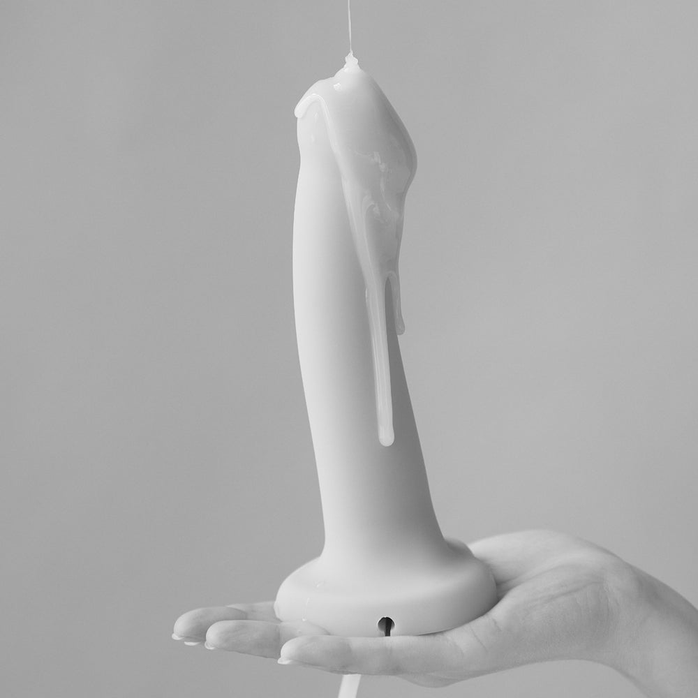 Strap-On-Me Small Squirting Cum Dildo Vanilla held in a hand with a realistic finish and built-in ejaculation system.