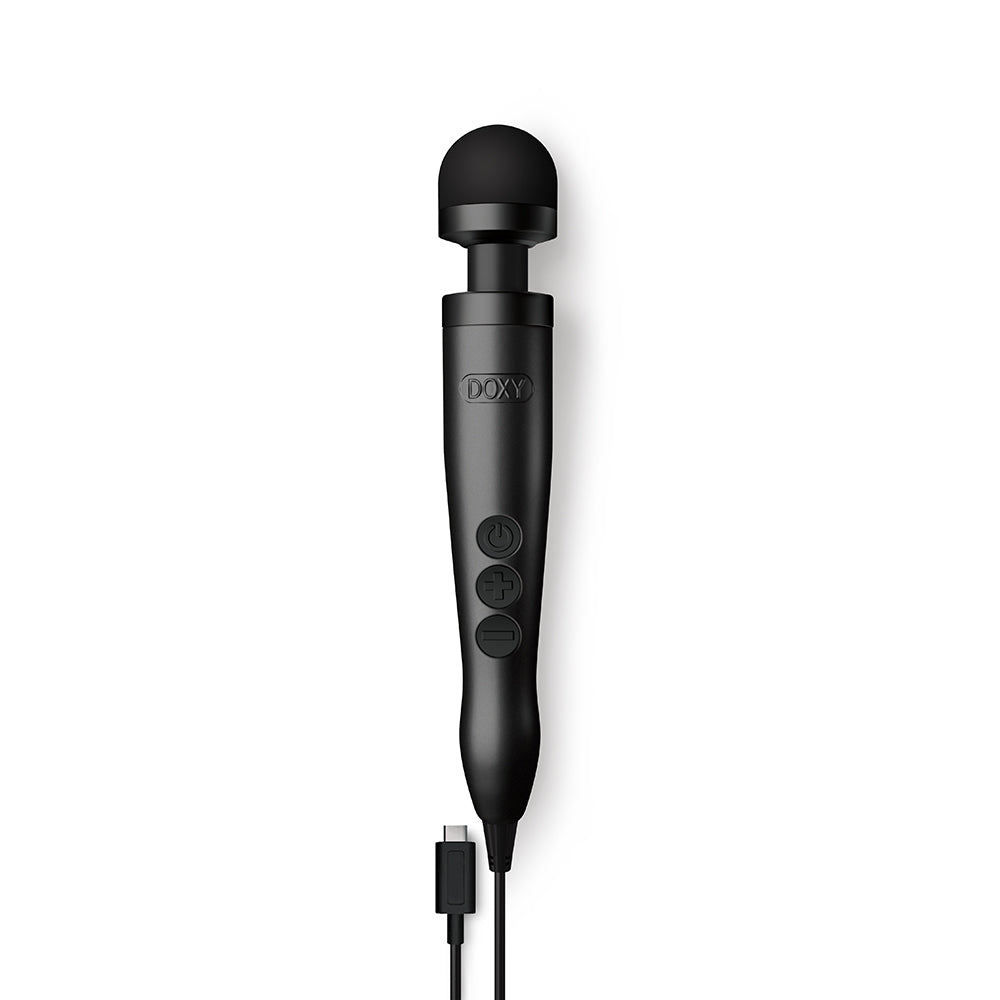 Doxy Usb-c Wand Massager Matte Black sitting on a surface with USB-C cable.