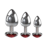 Adam & Eve Three Hearts Gem Anal Plug Set featuring three graduated aluminum plugs with red heart-shaped gems.