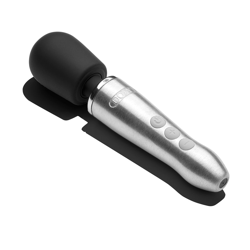 Doxy Go Travel-sized Wand Massager Brushed Metal on a surface showcasing its sleek design and controls.