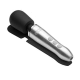 Doxy Go Travel-sized Wand Massager Brushed Metal on a surface showcasing its sleek design and controls.