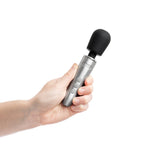 Doxy Go Travel-sized Wand Massager Brushed Metal held in hand, showcasing its sleek design and compact size.