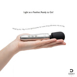 Doxy Go Travel-sized Wand Massager Brushed Metal in hand, showcasing its travel-friendly design and lightweight build.