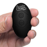 Loadz 8.5 inch Vibrating Squirting Dildo Dark remote control held in hand.