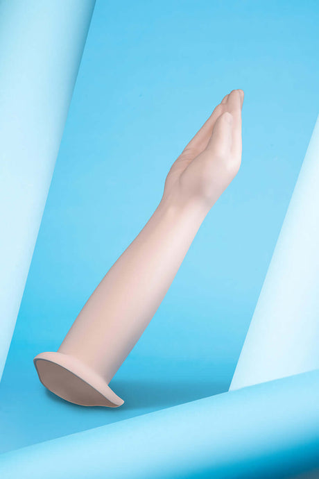 b-Vibe Silicone Hand Fisting Dildo shown on a blue backdrop highlighting its lifelike design and detail.