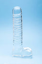 Clarity Seraphic Opus Glass Dildo on a blue background, showcasing its elegant design and handblown craftsmanship.