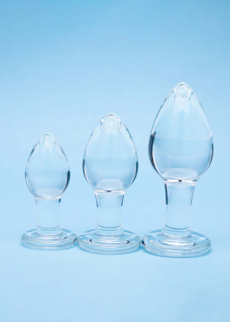 Clarity Utopian Trinity Glass Plug Set featuring three handcrafted borosilicate glass butt plugs of varying sizes.