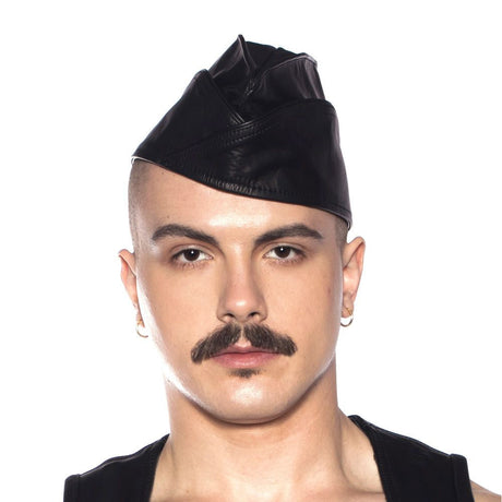Prowler RED Triangle Cap Black Small 55 cm worn by a model, showcasing a stylish leather look and confident expression.