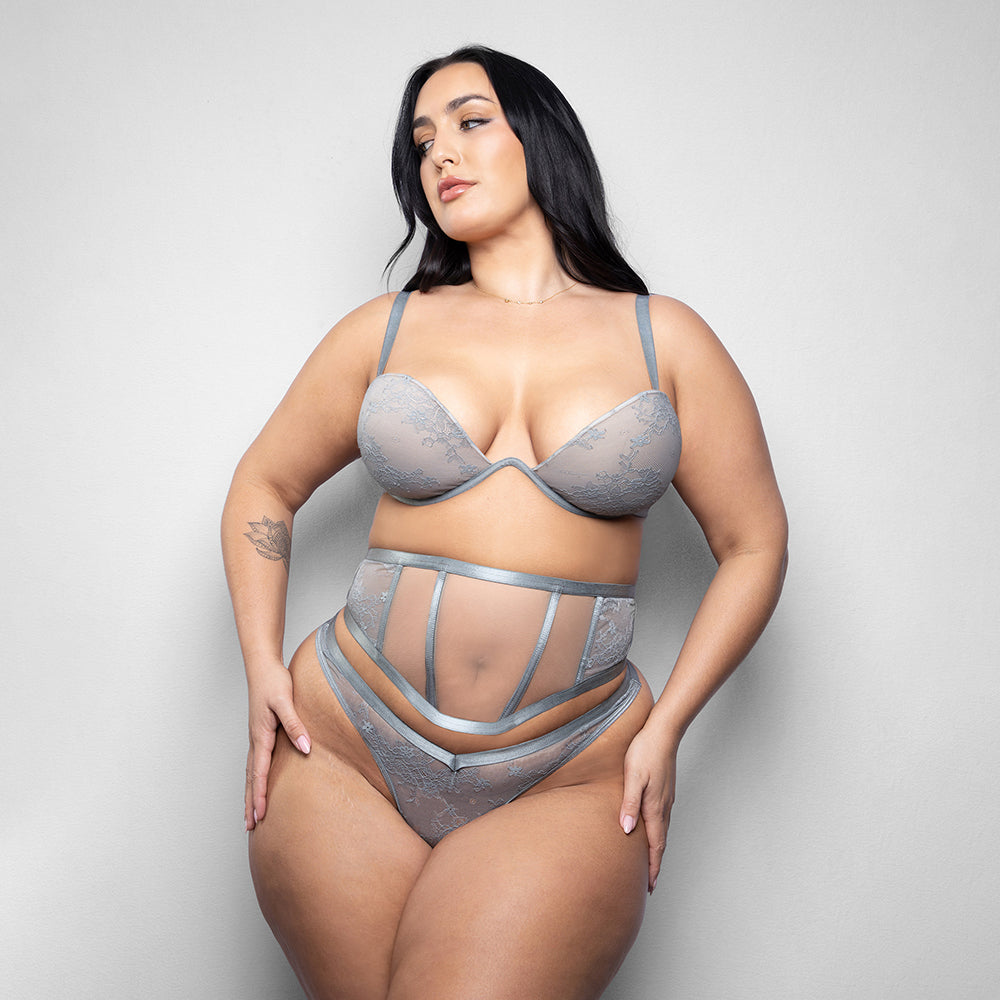 Fantasy Lingerie Elusive Mila Bra Cincher Thong Set 3X/4X in delicate gray lace on model.