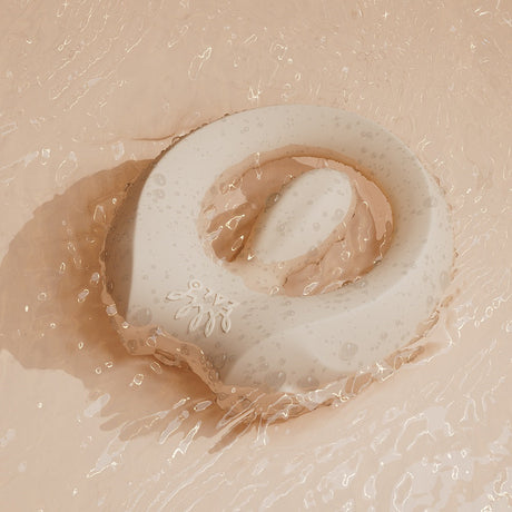 ZALO Apis Vibrating Couples Ring Ivory White resting in water, showcasing its sleek design and body-safe silicone.