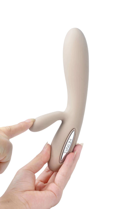 Svakom Lester Rechargeable Warming Rabbit Vibrator Khaki held in hand, showcasing its elegant design and functionality.