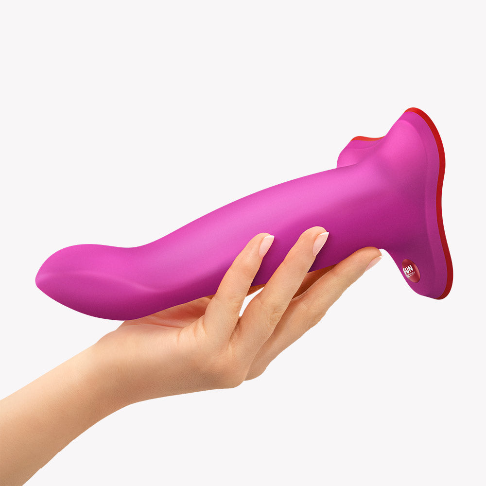 Fun Factory Limba Flex M Bendable Dildo Magenta held in hand, showcasing its flexible shaft and tapered tip.