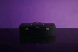 UPKO luxury black leather bondage tools case on a reflective surface with purple background. Ideal for BDSM accessories.