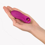 Fun Factory Bijou Bullet Vibrator Magenta in hand, showcasing its compact design and textured surface.