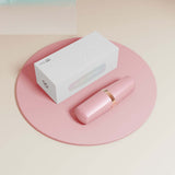 Sweet Secret Dual Massager Pink on a pink surface with its white packaging in the background.